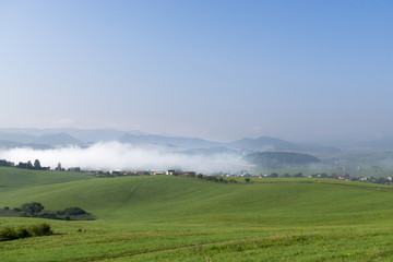 Fototapeta na wymiar Misty morning with the view to the fog on meadow. Slovakia