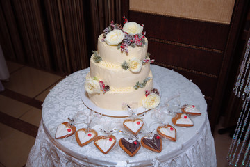 Sweet multilevel wedding cake decorated with beautiful flowers. Candy bar