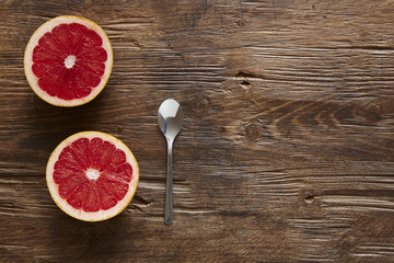 halfed organic grapefruit and spoon ready to eat
