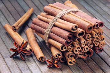 star anise and cinnamon sticks in a bunch on a wooden background