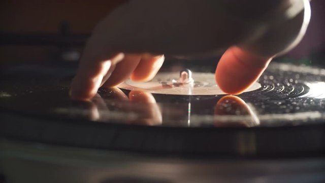 Man's hand scratching vinyl record