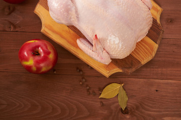 Fresh chicken on a wooden table