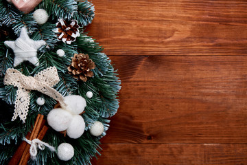 Christmas wreath on wooden background - Top view. Christmas decoration.