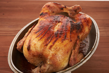 roasted bird on a wooden table