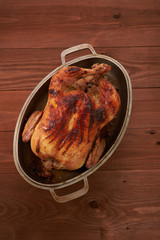 roasted bird on a wooden table