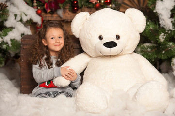 Little girl with a teddy bear for the new year