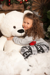 Little girl with a teddy bear for the new year