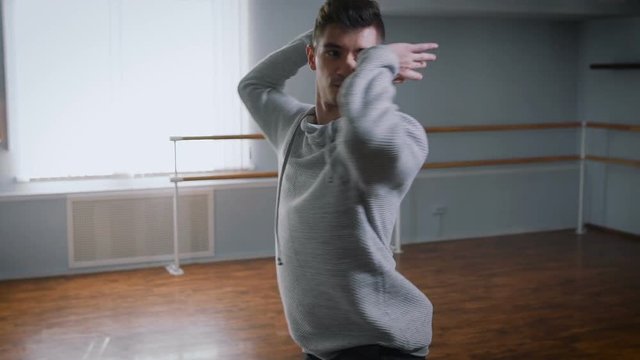 Hall for a rehearsal. The dance teacher rehearses the movements on the jazz to a modernist style. A modernist style a new trend in dances.