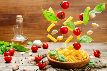 Flying pasta with tomatoes; garlic; cheese and basil