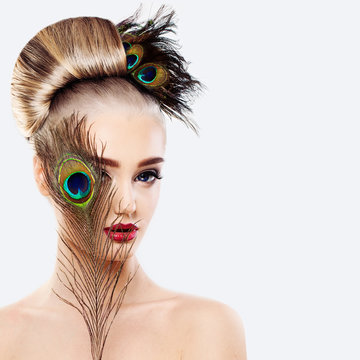 Glamorous Blonde Woman with Perfect Hairstyle, Makeup and Peacoc