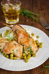 Oven Baked rabbit legs with potatoes and rosemary