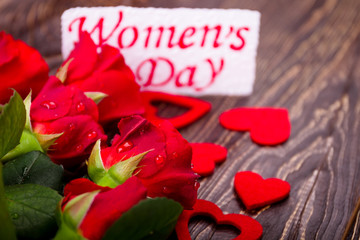 Women`s Day card and flowers. Hearts and wet roses. Express by actions, not words. Gift for charming lady.