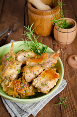 Oven Baked rabbit legs with potatoes and rosemary