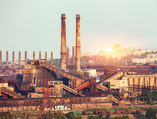 Metallurgical plant at colorful sunset. Industrial landscape. Steel factory in the city. Steel works, iron works. Heavy industry in Ukraine. Air pollution, ecology problems. Industrial buildings