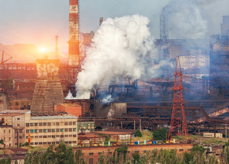 Metallurgy plant in Ukraine at sunset. Steel factory with smog. Pipes with smoke. Steel mill. Heavy...