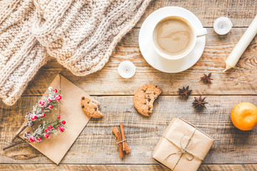 Christmas muffler with cup of cocoa wooden background top view