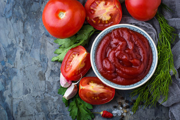 Tomato ketchup sauce on concrete background