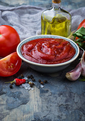 Tomato ketchup sauce on concrete background