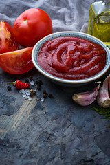 Tomato ketchup sauce on concrete background