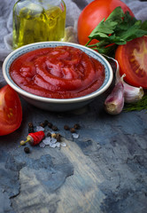 Tomato ketchup sauce on concrete background