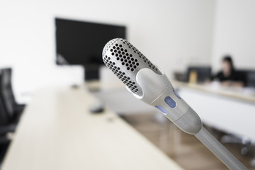 closeup microphone and blur people in conference room
