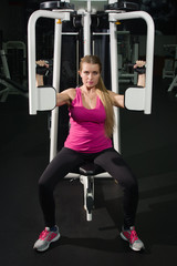 Fototapeta na wymiar Fit female training in gym