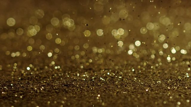 Golden glitter dynamic movements in slow motion