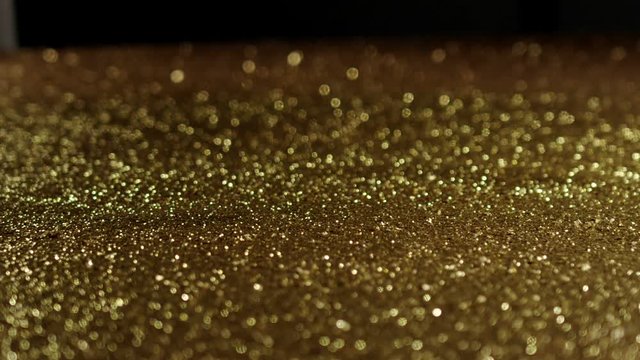 Golden glitter dynamic movements in slow motion