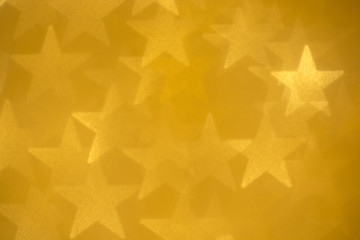 De-focused golden stars rough abstract glamour background
