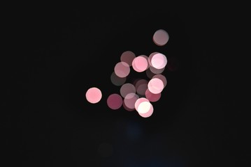 Light blur and defocus bokeh circles on black sky background