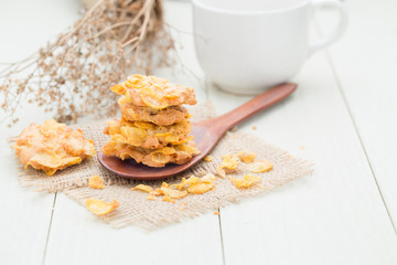 crispy cereal cookies on white wooden table