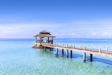 Pier in tropical turquoise clear water, beach travel destination
