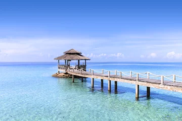 Fotobehang Pier in tropical turquoise clear water, beach travel destination © NicoElNino