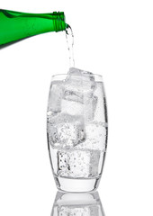 Pouring fresh sparkling water from bottle to glass