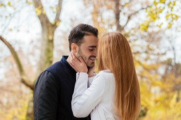 Fototapeta premium Beautiful stylish young couple hugging on the background park