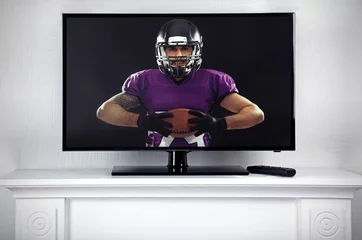 Foto op Canvas Watching American football game on television at home. Leisure and entertainment concept. © Africa Studio