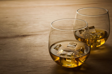 glass of whiskey on wooden table