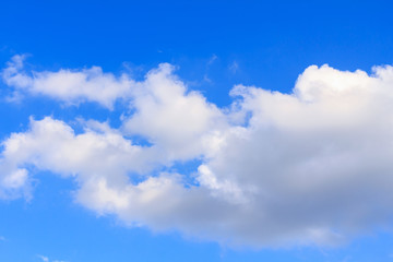 Plakat Blue sky background with white clouds and rain clouds. The vast blue sky and clouds sky on sunny day. White fluffy clouds in the blue sky.