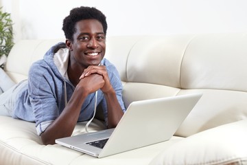 African-American man with laptop.