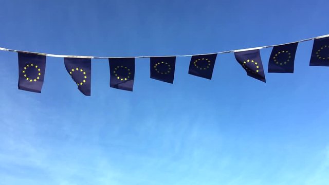 European Union flag bunting flying in bright blue sky