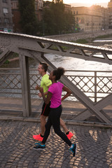 young multiethnic couple jogging in the city