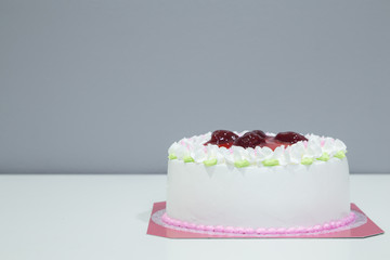 white biirthday cake with strawberry