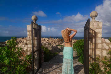 Blonde woman at the doors of the dragon's breath in Labadee, Haiti.