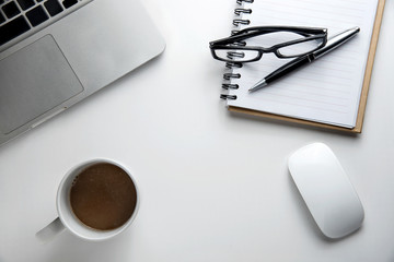 Desk with office supplies and cup of coffee, top view