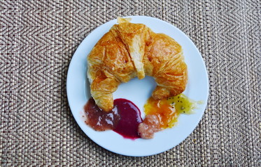 butter croissant and assorted jam on dish