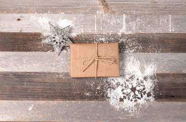 Christmas gift and ornaments on the wooden background