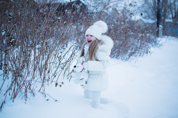 funny girl walking on the street on a winter day