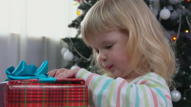 Little girl opens new year's gift