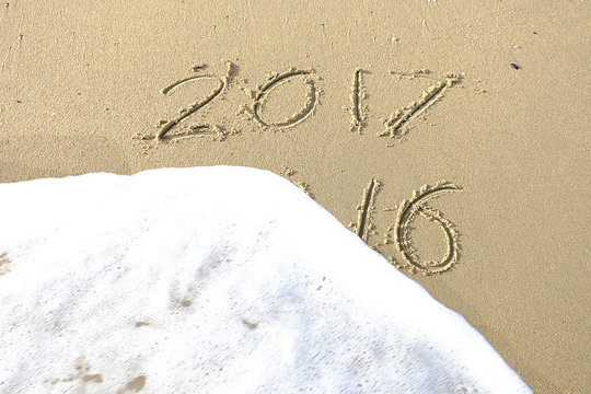 Good bye 2016 hello 2017. inscription written in the beach sand.