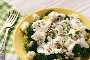Broccoli salad with feta cheese, garlic dressing and sunflower seeds.